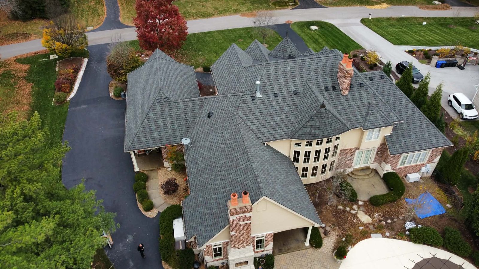 Wide aerial of a completed multi-gable estate roof